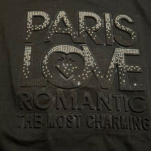Black shirt w/rhinestones. Paris love is raised on the t-shirt. Fits size s/m.